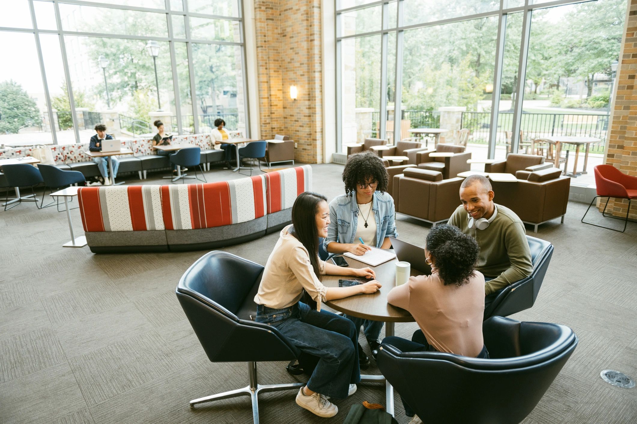 University students gathered around a table in discussion
