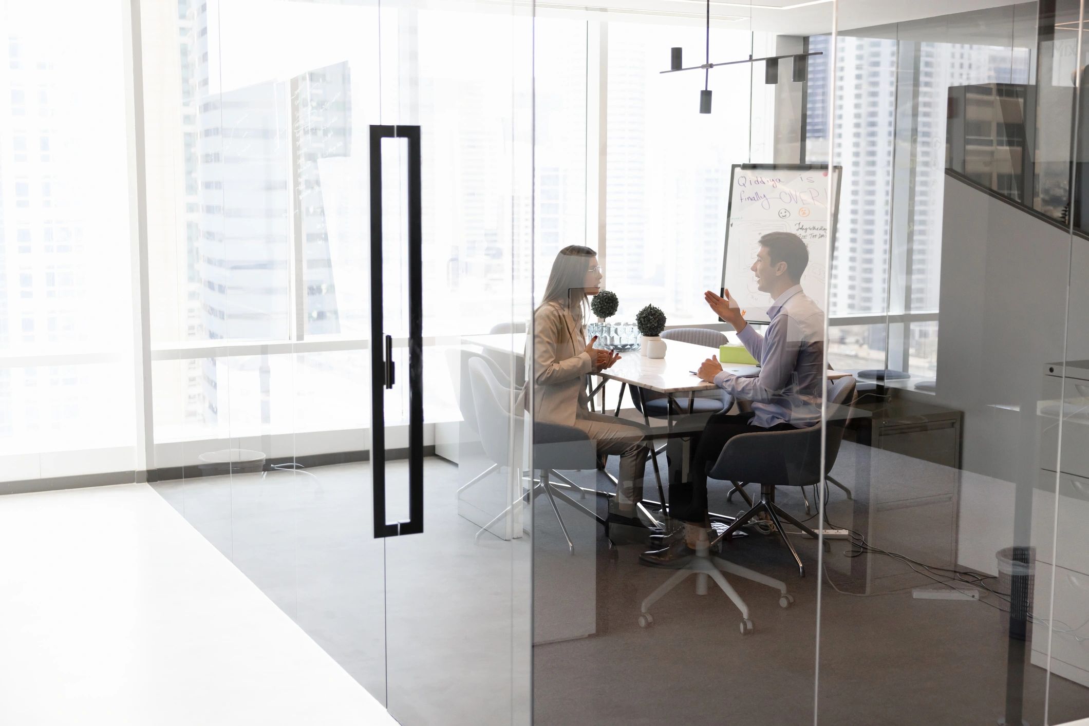 Two male and female business leaders discussing company management